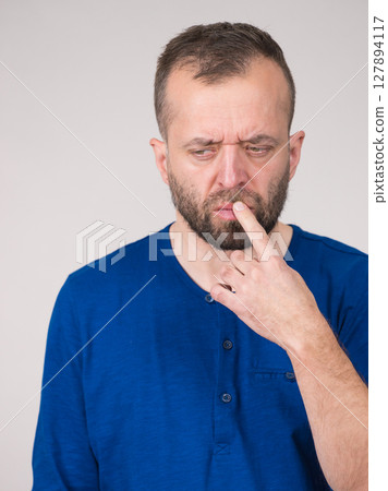 Confused focused serious man thinking Confused focused serious man thinking 127894117