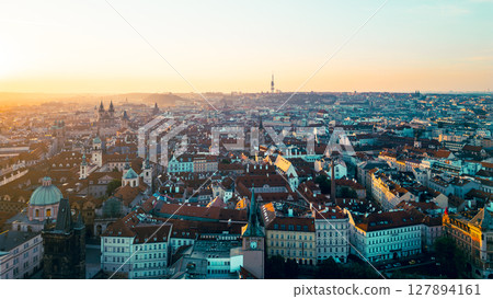 The stunning panorama showcases Old Town Prague at sunrise, illuminating the historic architecture along the Vltava River. 127894161