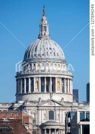 The magnificent dome of St. Paul's Cathedral rises majestically against a clear blue sky. This iconic landmark showcases London's rich architectural history and attracts many visitors daily. The magnificent dome of St. Paul's Cathedral rises majestically against a clear blue sky. This iconic landmark showcases London's rich architectural history and attracts many visitors daily. 127894249