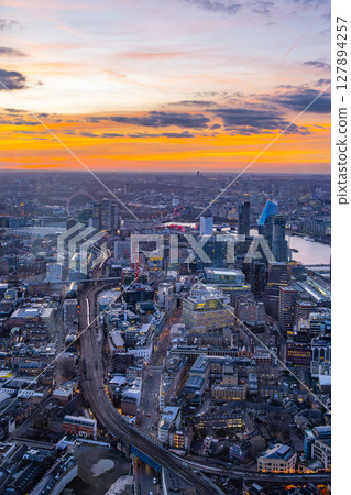 Spectacular sunset envelops London from The Shard, casting vibrant colors over the skyline, bustling streets, and iconic landmarks. A breathtaking sight showcasing the city's beauty at dusk. Spectacular sunset envelops London from The Shard, casting vibrant colors over the skyline, bustling streets, and iconic landmarks. A breathtaking sight showcasing the city's beauty at dusk. 127894257