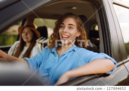 Two young women on car trip having fun. Lifestyle, travel, tourism, nature, active life. Two young women on car trip having fun. Lifestyle, travel, tourism, nature, active life. 127894652