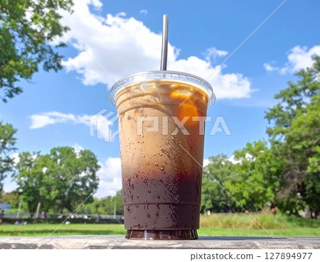 Takeaway iced coffee in a park on a hot day AI-generated image Takeaway iced coffee in a park on a hot day AI-generated image 127894977