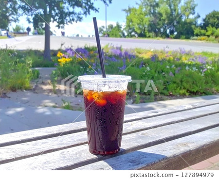 Takeaway iced coffee on an outdoor bench AI-generated image Takeaway iced coffee on an outdoor bench AI-generated image 127894979