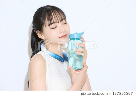Portrait of a young woman taking measures against the heat Portrait of a young woman taking measures against the heat 127895597