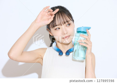 Portrait of a young woman taking measures against the heat Portrait of a young woman taking measures against the heat 127895598