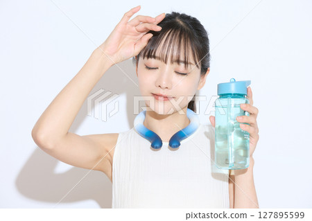 Portrait of a young woman taking measures against the heat Portrait of a young woman taking measures against the heat 127895599