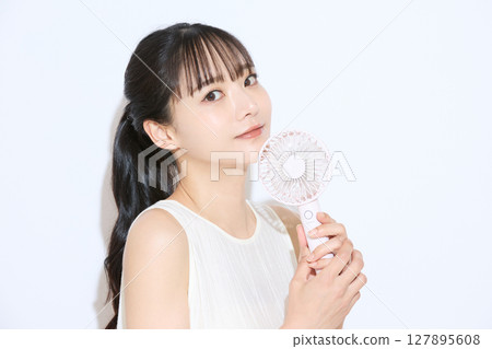 Portrait of a young woman taking measures against the heat Portrait of a young woman taking measures against the heat 127895608