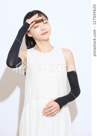 Portrait of a young woman taking measures against the heat Portrait of a young woman taking measures against the heat 127895620