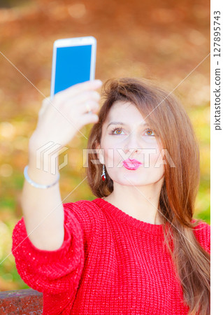 Gorgeous girl taking selfie. 127895743