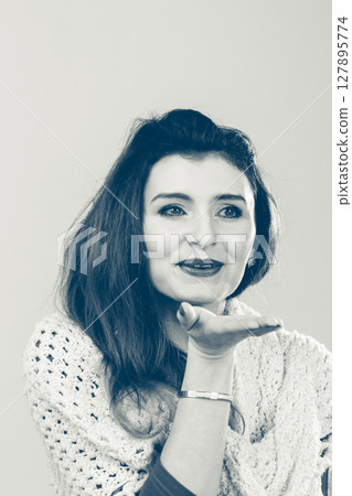 Beautiful woman blowing kiss Beautiful woman blowing kiss 127895774