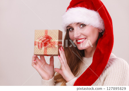 Woman holding gift box. Christmas time 127895829