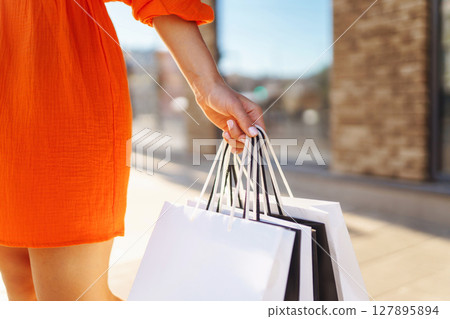 Young woman with shopping bags near mall. Purchases, shopping, lifestyle, sale concept. Young woman with shopping bags near mall. Purchases, shopping, lifestyle, sale concept. 127895894