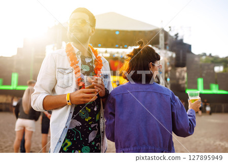Group of friends with beer dancing and having fun at music festival together. Summer Beach party. Group of friends with beer dancing and having fun at music festival together. Summer Beach party. 127895949