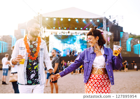 Group of friends with beer dancing and having fun at music festival together. Summer Beach party. 127895954