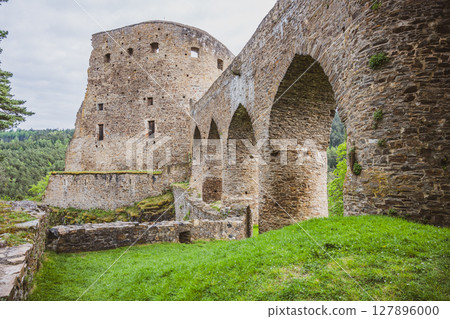 Nestled in the scenic landscape of Czechia, Velhartice Castle features a stunning Gothic bridge that connects ancient stone structures. 127896000