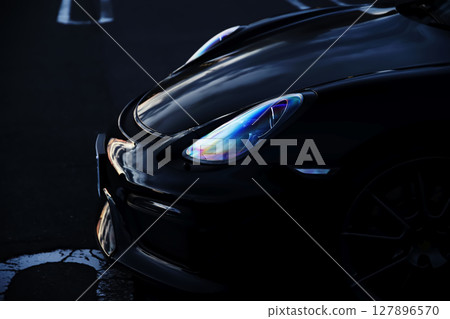 Black sports car headlights 127896570