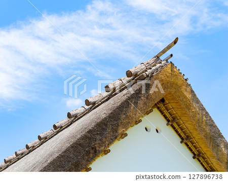 An old private house with a thatched roof An old private house with a thatched roof 127896738