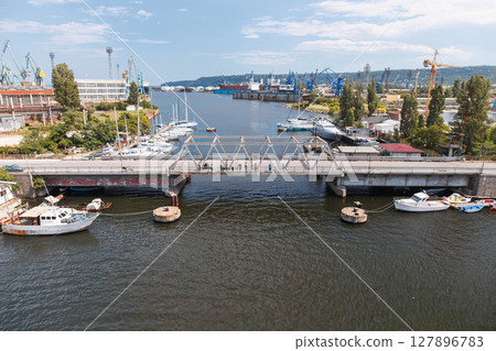 A vibrant industrial port area featuring an old bridge over Varna lake A vibrant industrial port area featuring an old bridge over Varna lake 127896783