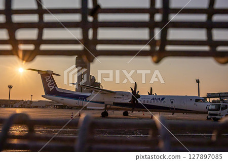Airplane at dusk 127897085