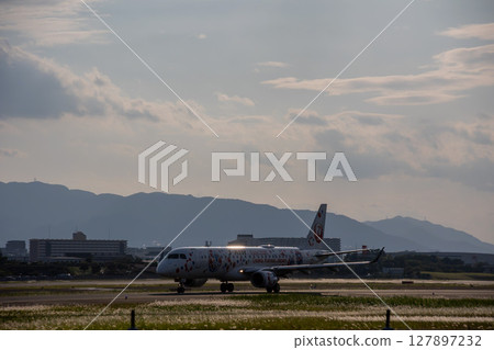 Airplane at dusk 127897232