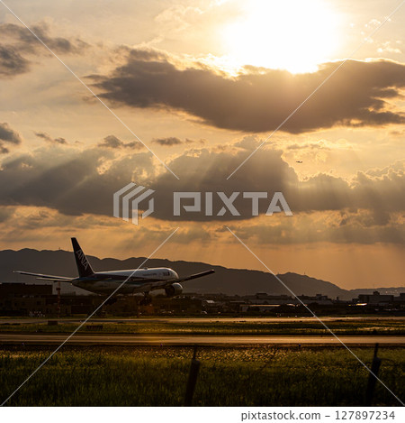 Airplane at dusk 127897234