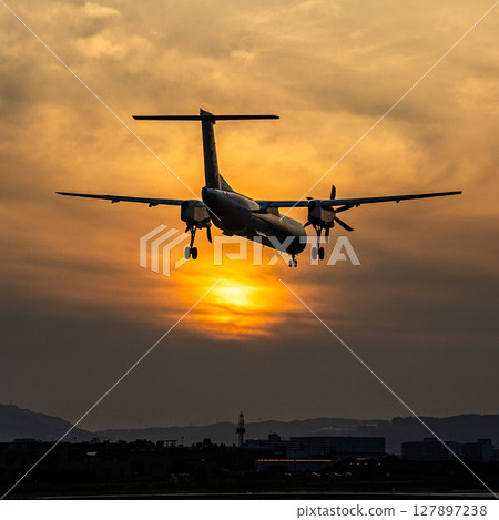 Airplane at dusk 127897238