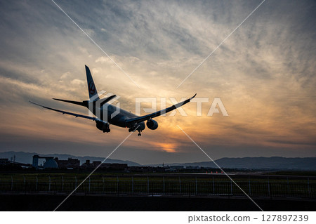 Airplane at dusk Airplane at dusk 127897239