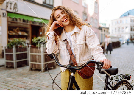 Portrait of beautiful young woman enjoying time on bicycle. Active lifestyle. Eco transport. Portrait of beautiful young woman enjoying time on bicycle. Active lifestyle. Eco transport. 127897859