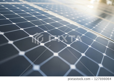 Close up view of a solar panel array, highlighting the grid like structure of photovoltaic cells capturing sunlight and converting it into clean electricity 127898064