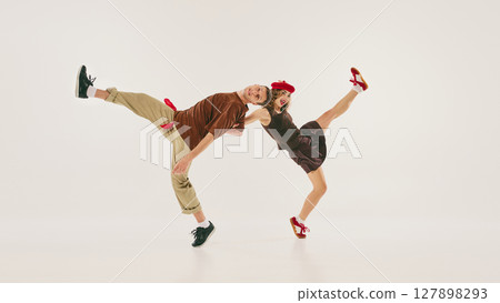 Energetic dancers perform dynamic lindy hop routine with retro style and vibrant enthusiasm Energetic dancers perform dynamic lindy hop routine with retro style and vibrant enthusiasm 127898293