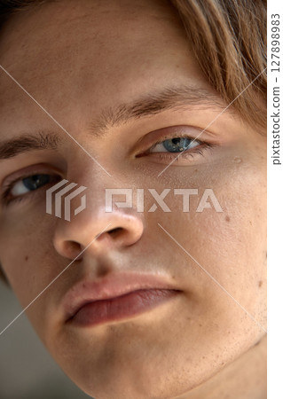 Skin-realism. Close-up of a mans skin, visible pores, light stubble, shine on the forehead. 127898983