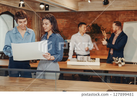Participating in a Collaborative and Productive Team Meeting in a Modern Office Environment Setup 127899481