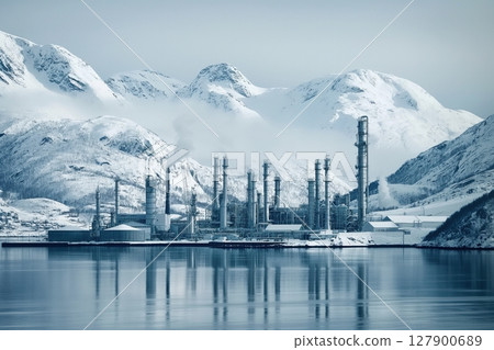 Oil refinery operates near a fjord in snowy norway, creating an industrial landscape in winter 127900689