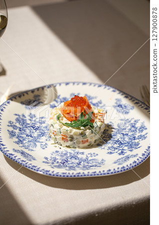 Portion of gourmet olivier salad with salmon Portion of gourmet olivier salad with salmon 127900878
