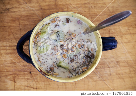 Bowl of natural Muesli with kiwi from above Bowl of natural Muesli with kiwi from above 127901835