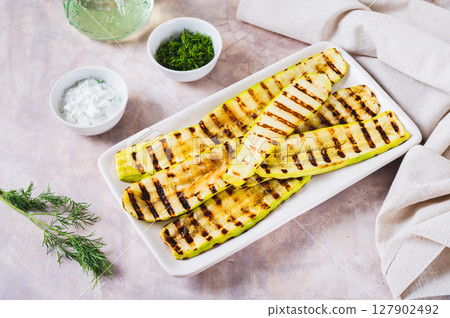 Delicious grilled vegetable zucchini on a plate on the table 127902492