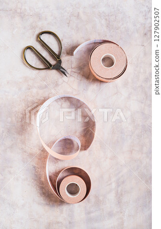 Beige special physical tapes for face and body on the table top and vertical view Beige special physical tapes for face and body on the table top and vertical view 127902507