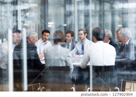 Group of Executives in a Boardroom Discussing Strategy in a Corporate Meeting Setting Group of Executives in a Boardroom Discussing Strategy in a Corporate Meeting Setting 127902904