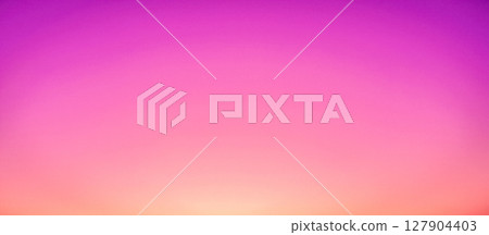 Breathtaking sunset over a calm ocean with a bright sun on the horizon, a romantic pink and purple seascape background 127904403