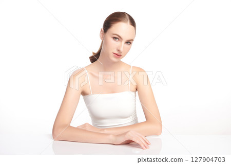 A beautiful young woman with clean, fresh skin against a white background. Skincare, facial treatment, cosmetology, beauty, and spa. An elegant portrait of an woman. A beautiful young woman with clean, fresh skin against a white background. Skincare, facial treatment, cosmetology, beauty, and spa. An elegant portrait of an woman. 127904703