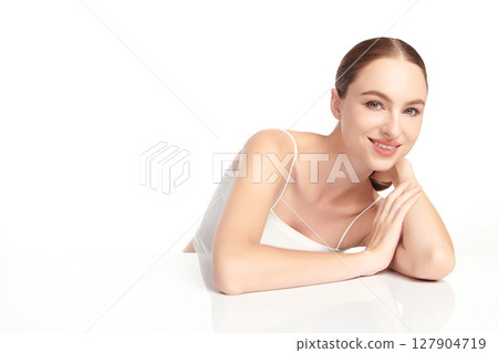 A beautiful young woman with clean, fresh skin against a white background. Skincare, facial treatment, cosmetology, beauty, and spa. An elegant portrait of an woman. A beautiful young woman with clean, fresh skin against a white background. Skincare, facial treatment, cosmetology, beauty, and spa. An elegant portrait of an woman. 127904719