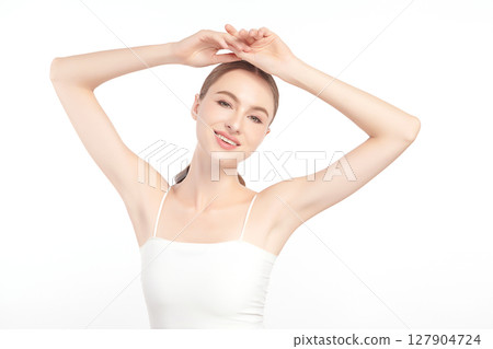 Beautiful Young woman Raises her hands to Showcase clean and hygienic underarms Against a white background, Smooth armpit cleanliness and protection concept Beautiful Young woman Raises her hands to Showcase clean and hygienic underarms Against a white background, Smooth armpit cleanliness and protection concept 127904724