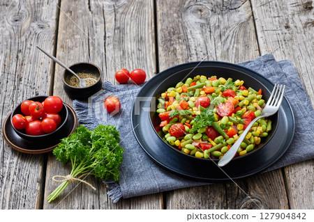 succotash of corn, beans, tomatoes, in black bowl 127904842
