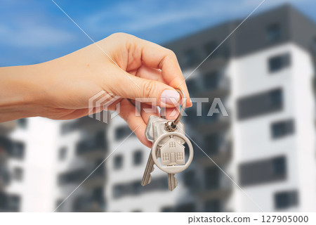 Woman holding key to new home 127905000