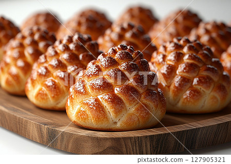 Homemade bakes. Christmas buns in the shape of a pine cone in on a wooden trading tray on a white background. 127905321