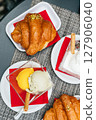 Croissant with pistachio and mango scoops of gelato in italian cafe 127906040