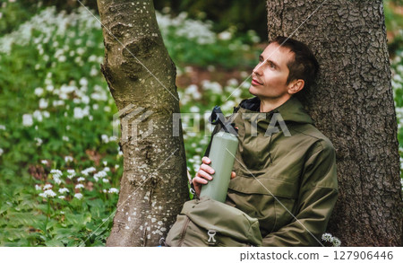 Man Walking through Blooming Forest Glade Man Walking through Blooming Forest Glade 127906446