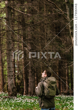 Man Hiker Walking through Spring Forest Man Hiker Walking through Spring Forest 127906448