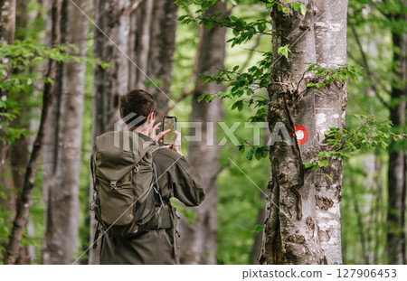 Man Using Map App on Phone in Forest Man Using Map App on Phone in Forest 127906453