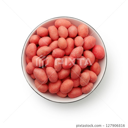 Top view of red spicy coated peanuts in bowl 127906816